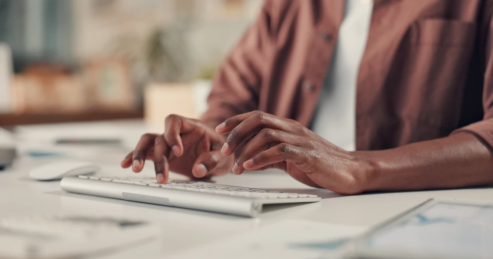 Une personne utilise un ordinateur portable dans un environnement de bureau moderne
